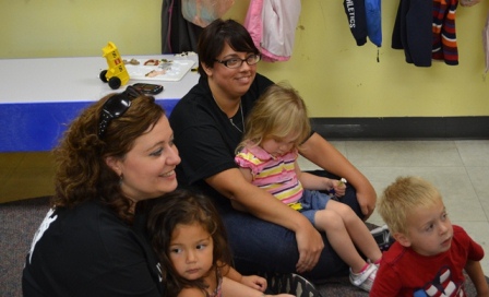Deputy Secretary Anna Pilato, left, and Assistant Director Melissa Ward got to hold kids during storytime.