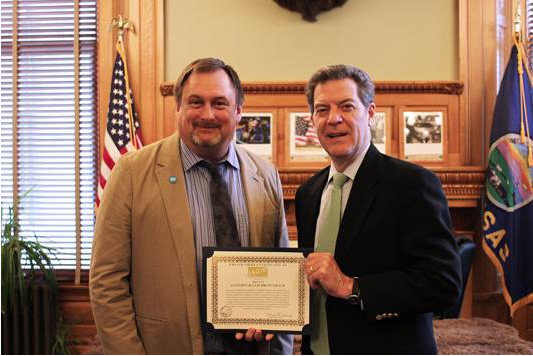 Governor Brownback presented challenge coin from Kansas branch of Jobs for America's Graduates