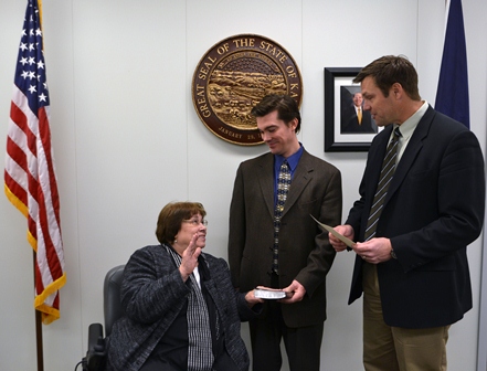 Secretary of State Kris Kobach administered the oath of office to Acting Secretary Gilmore with her son, Andy.