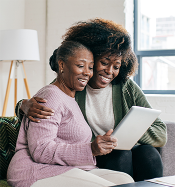 Image of 2 women looking at the tablet together